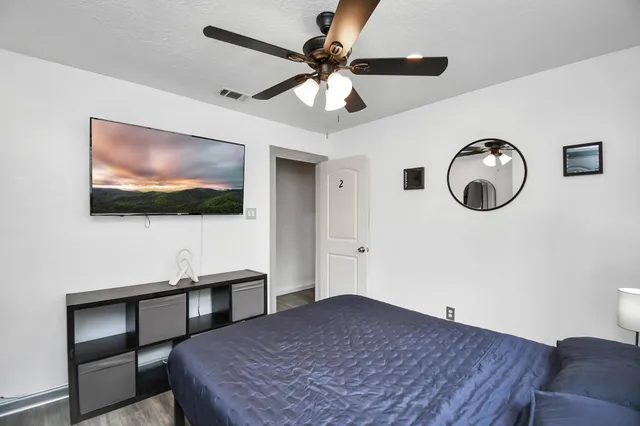 a bedroom with a bed and a flat screen tv