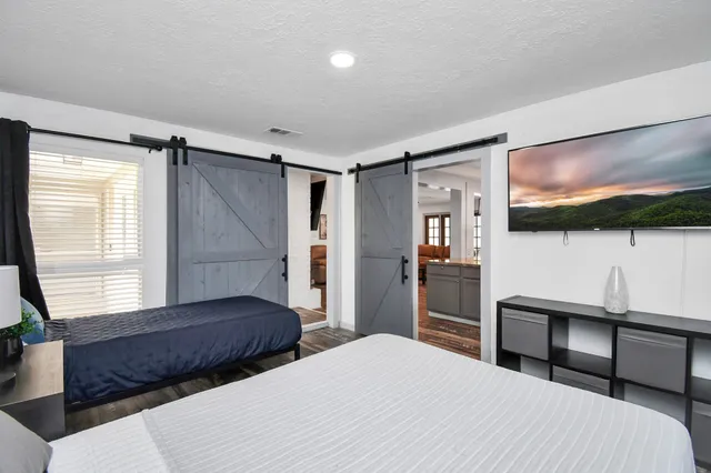 a bedroom with a bed and a flat screen tv