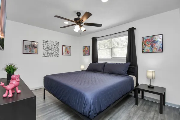 a bedroom with a bed and a chandelier
