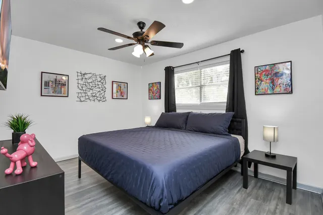 a bedroom with a bed and a chandelier