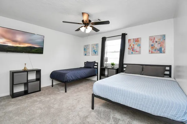 a bedroom with a large bed and a flat screen tv