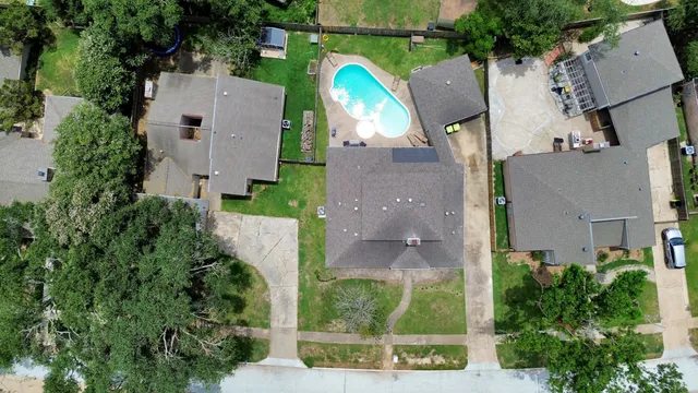 an aerial view of a house with outdoor space and a lake view