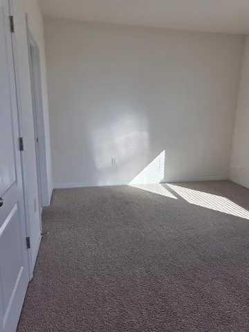 a bathroom with a granite countertop sink a toilet and a mirror
