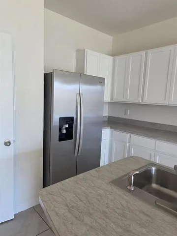a kitchen with stainless steel appliances granite countertop a sink and a stove
