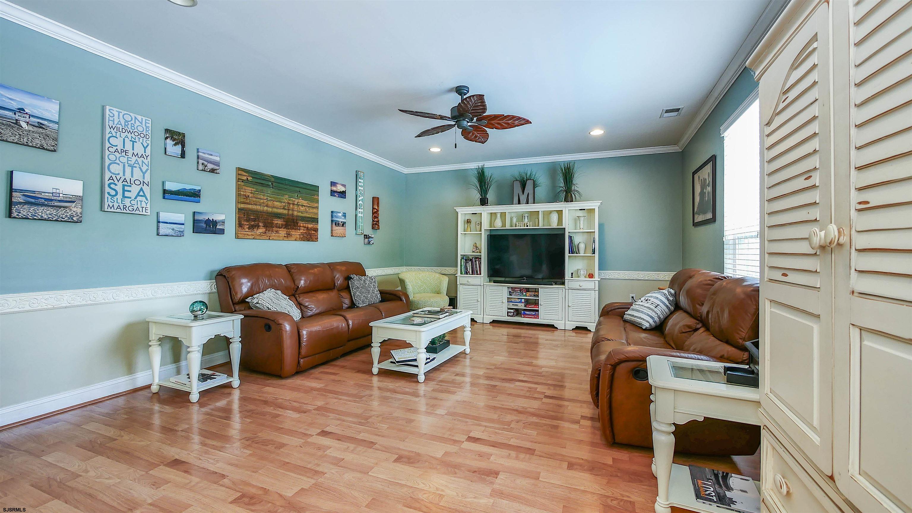 101 Haviv Drive Northfield, NJ 08225 - Photo 12 of 38 a living room with furniture a flat screen tv and kitchen view