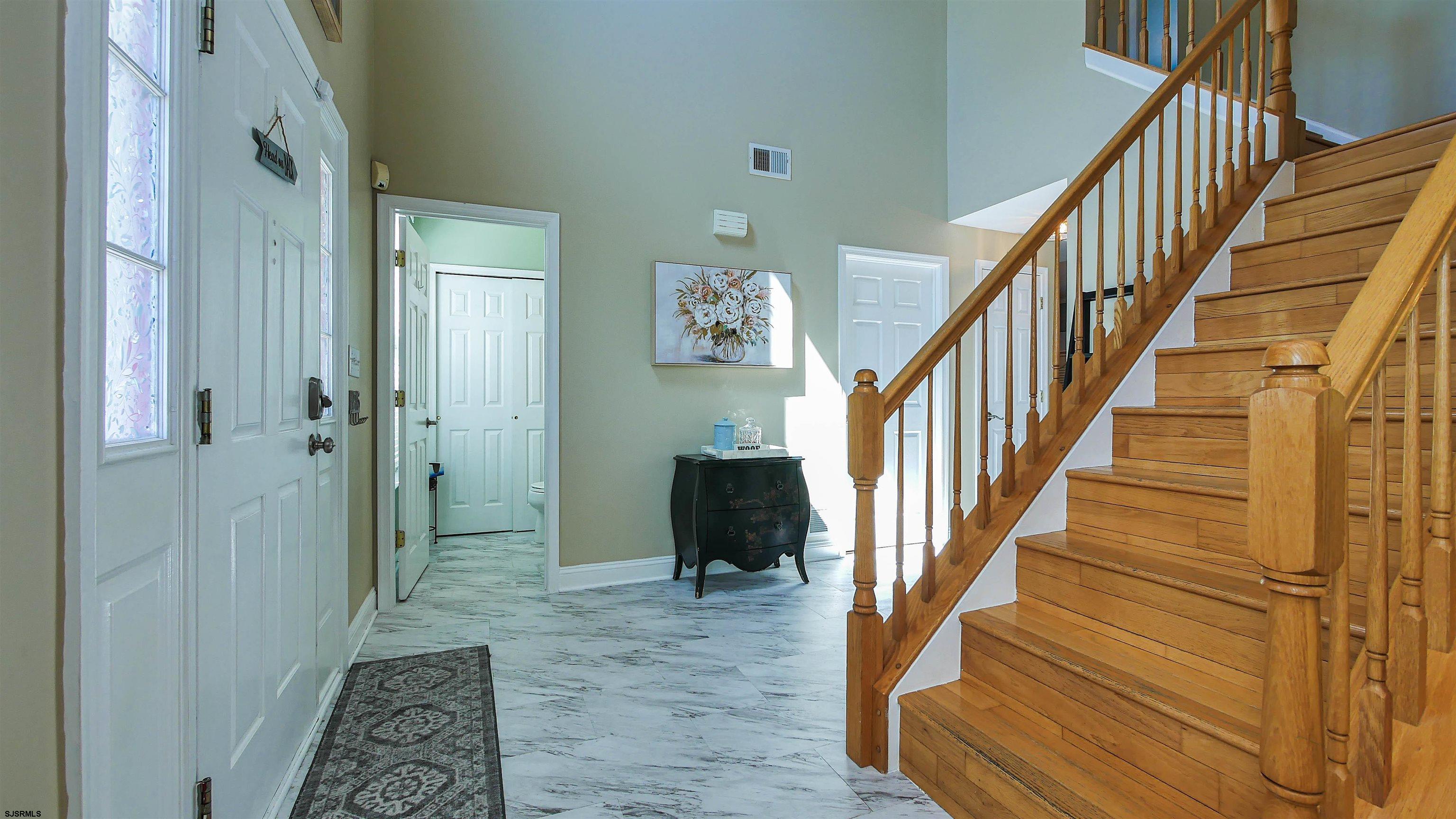 101 Haviv Drive Northfield, NJ 08225 - Photo 15 of 38 a view of a hallway with wooden floor and entryway
