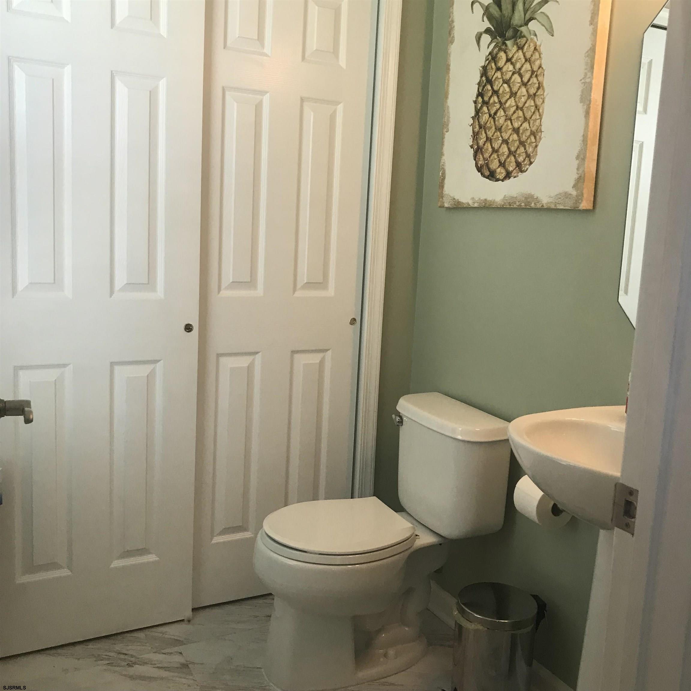 101 Haviv Drive Northfield, NJ 08225 - Photo 16 of 38 a white toilet sitting next to a shower curtain
