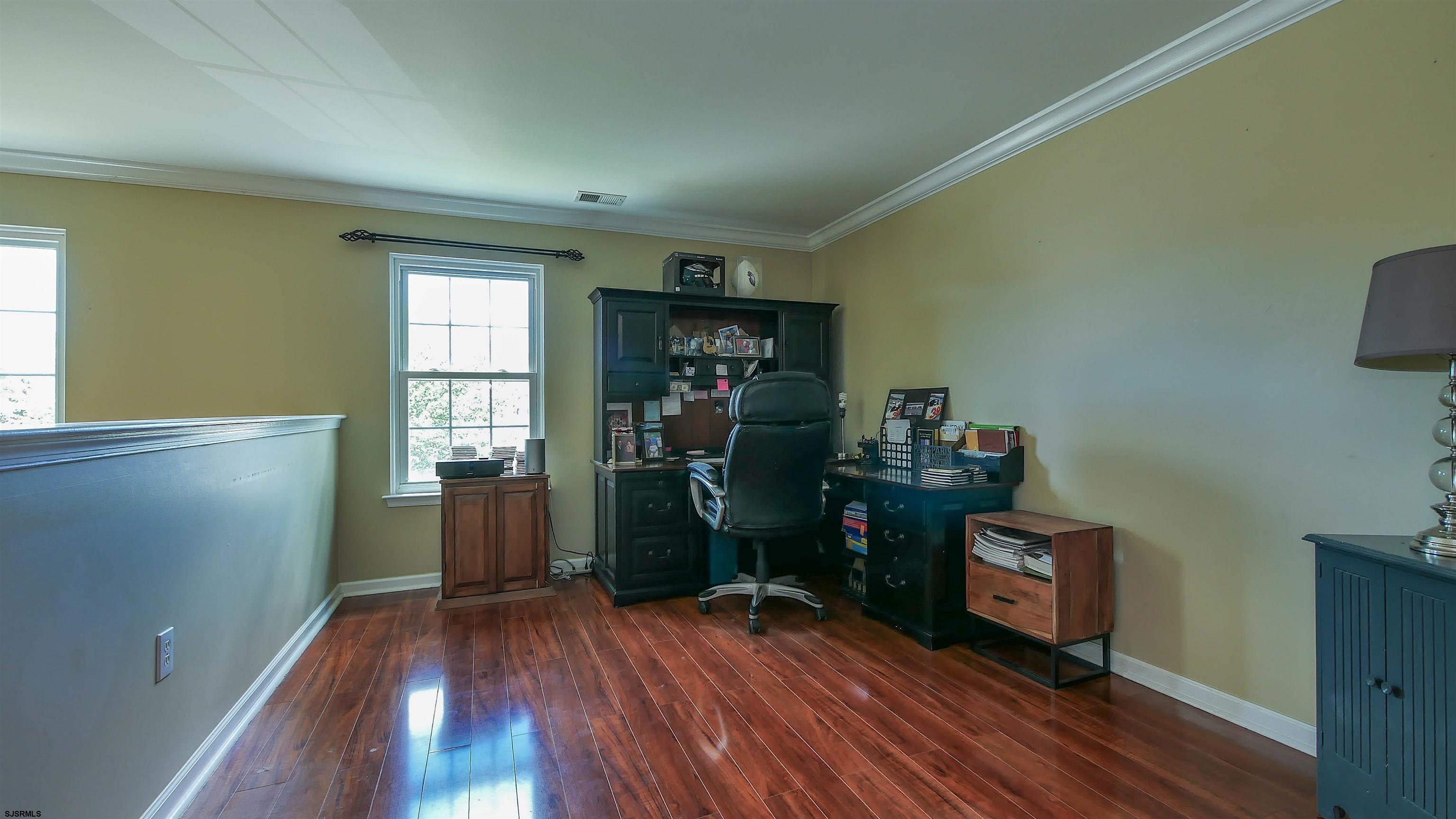 101 Haviv Drive Northfield, NJ 08225 - Photo 19 of 38 a view of a room with gym equipment and wooden floor