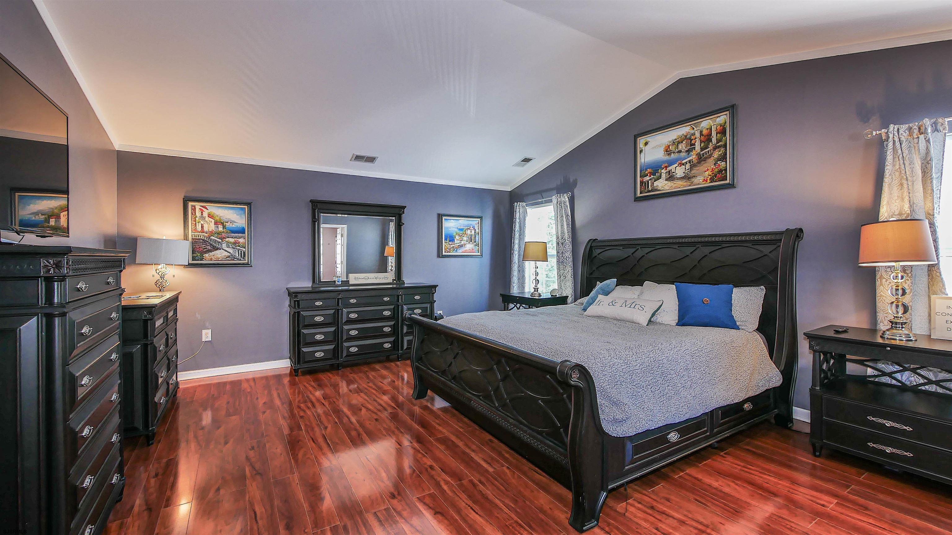 101 Haviv Drive Northfield, NJ 08225 - Photo 20 of 38 a bedroom with a bed and wooden floor