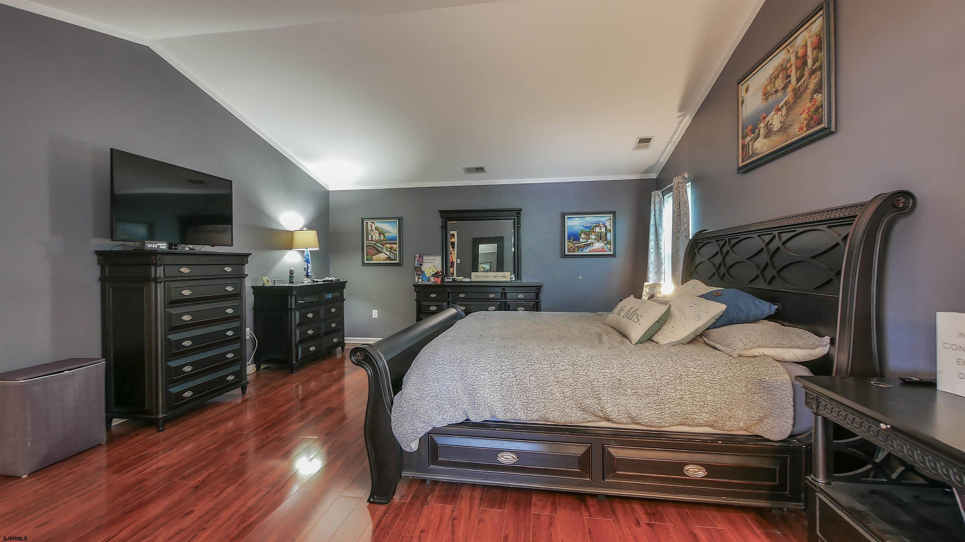 101 Haviv Drive Northfield, NJ 08225 - Photo 22 of 38 a bedroom with a bed and flat screen tv