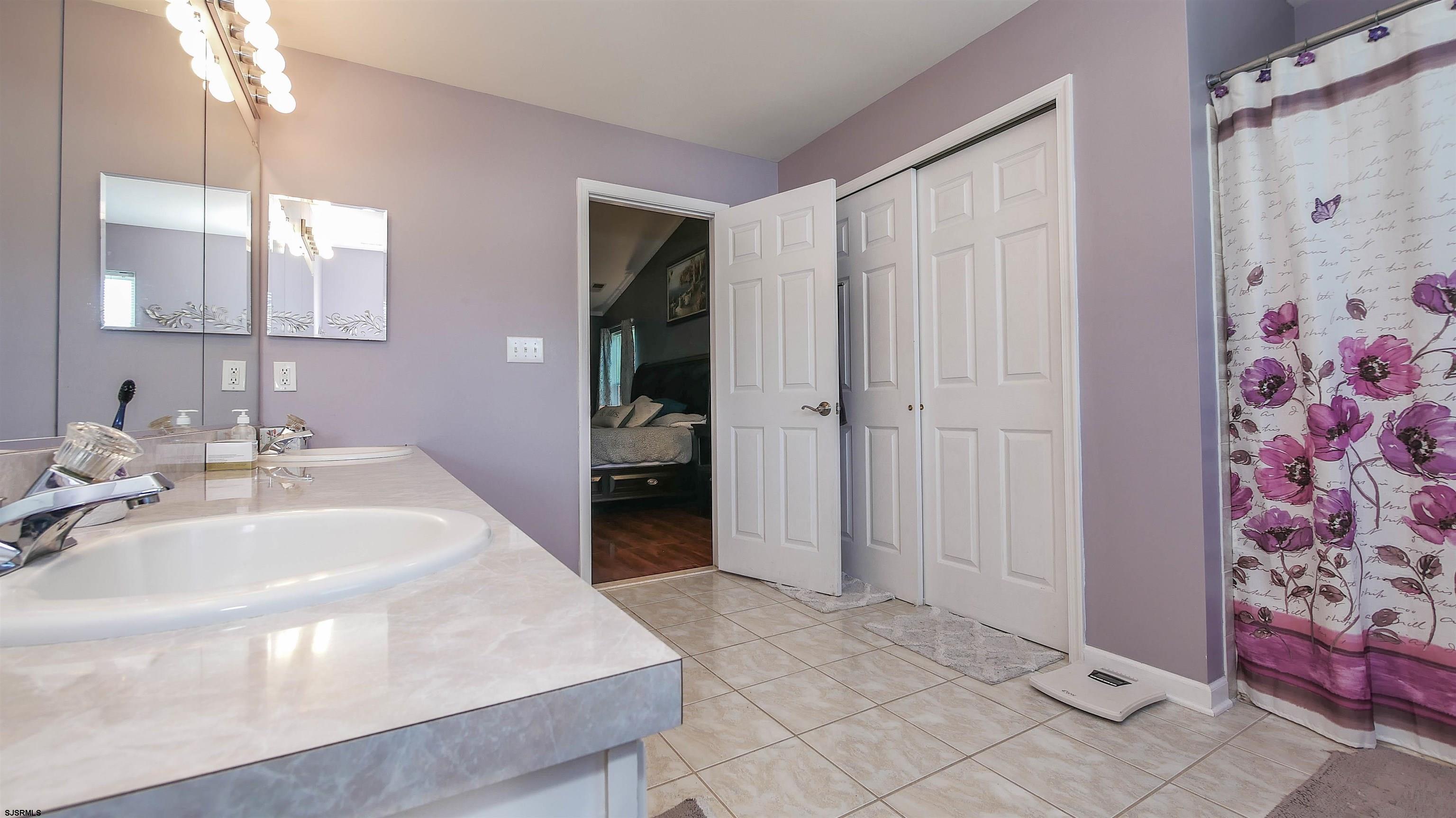 101 Haviv Drive Northfield, NJ 08225 - Photo 25 of 38 a spacious bathroom with a sink and a mirror