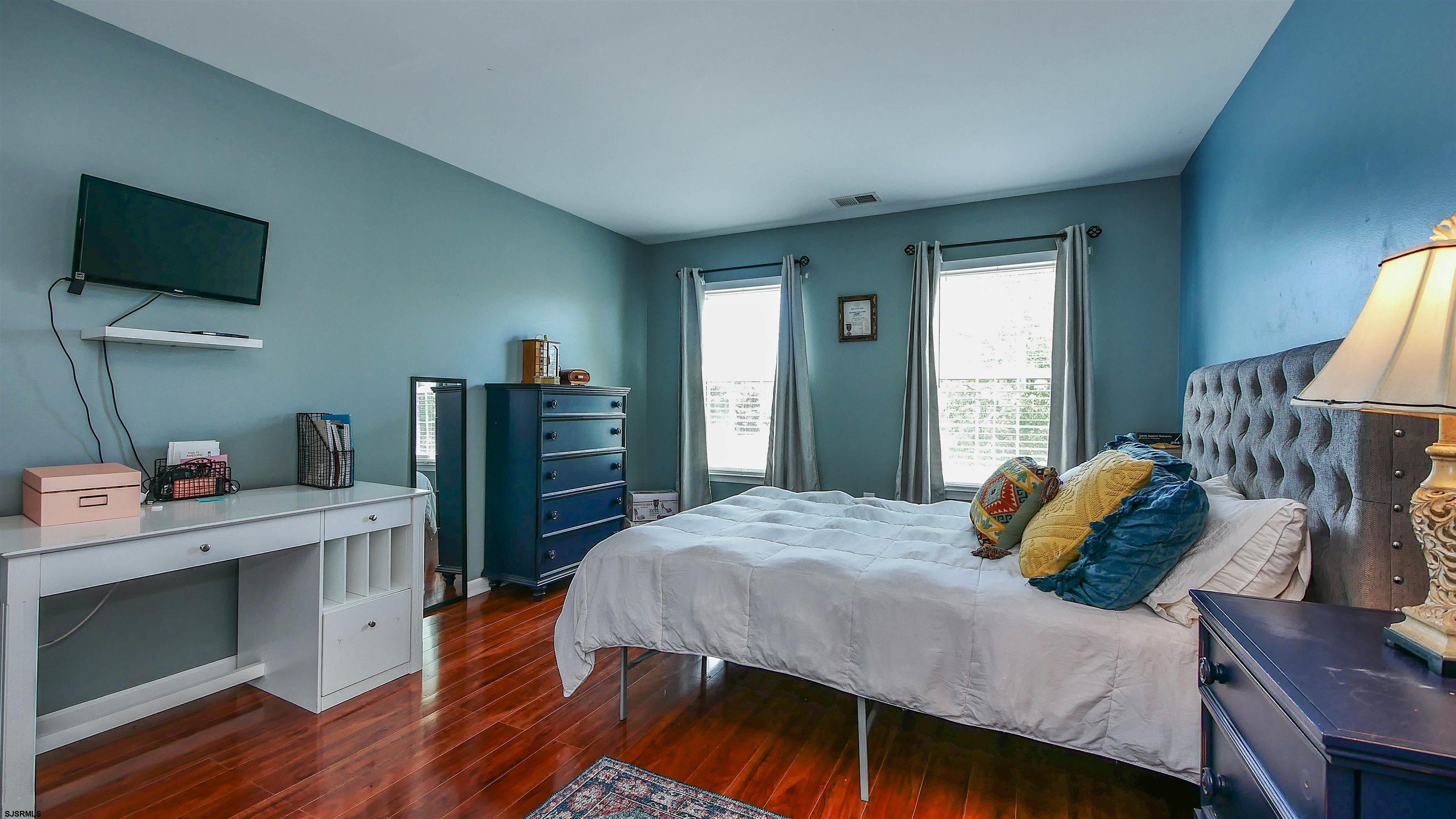 101 Haviv Drive Northfield, NJ 08225 - Photo 29 of 38 a bedroom with a bed and a flat screen tv