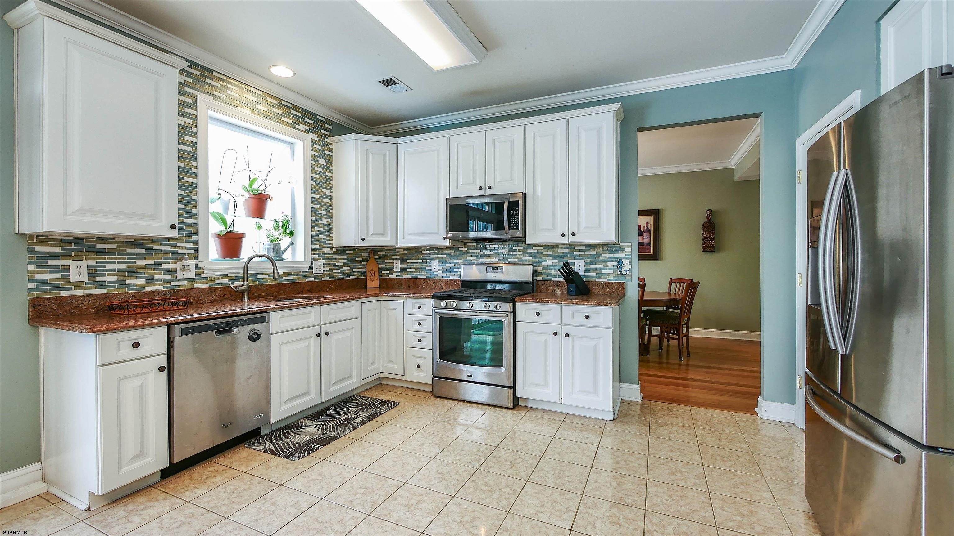 101 Haviv Drive Northfield, NJ 08225 - Photo 8 of 38 a kitchen with stainless steel appliances granite countertop a refrigerator and a stove top oven