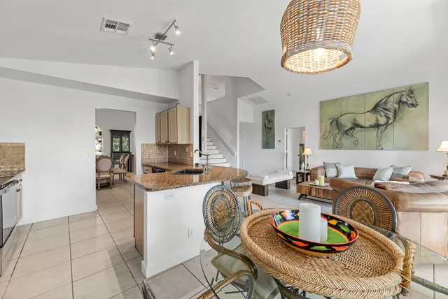 a living room with furniture a window and kitchen view