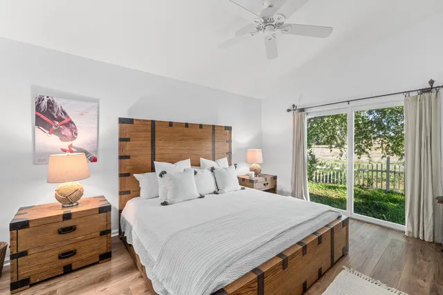 a bedroom with a bed and a large window