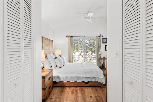 a bedroom with a bed window and walk in closet with bedroom view