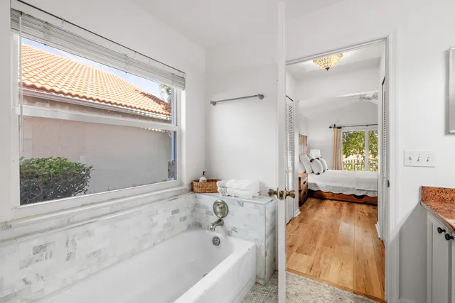 a en suite bathroom with a tub and window