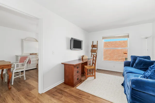 a livingroom with workspace and a couch