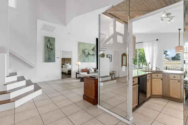 a kitchen with stainless steel appliances kitchen island granite countertop a refrigerator and a sink