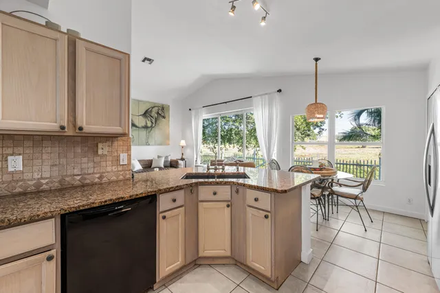 a kitchen with a sink window and cabinets