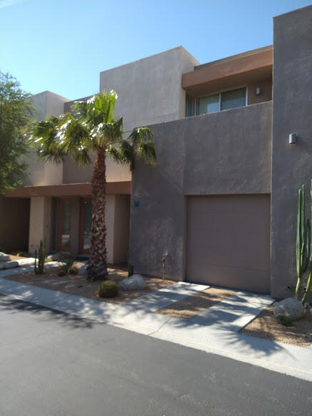 225 Sandy Point Trail Palm Springs, CA 92262 - Photo 2 of 38 a front view of a house with a yard and a garage