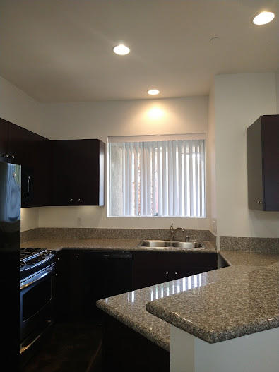 225 Sandy Point Trail Palm Springs, CA 92262 - Photo 22 of 38 a kitchen with granite countertop a sink and a stove top oven
