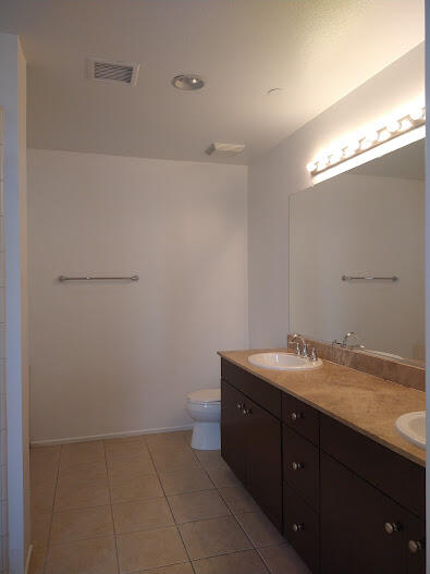 225 Sandy Point Trail Palm Springs, CA 92262 - Photo 29 of 38 a bathroom with a granite countertop sink and a mirror