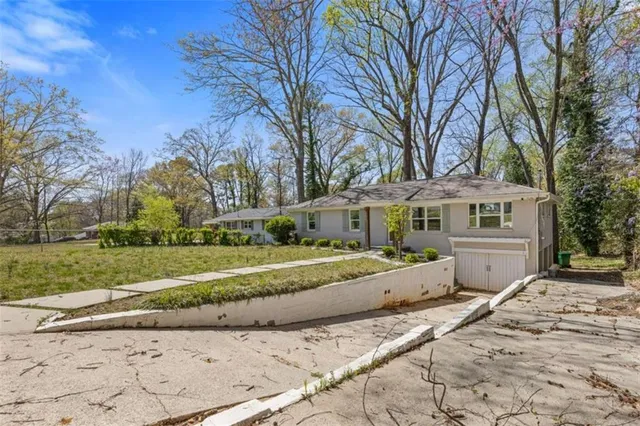 a view of a house with a yard covered in and trees