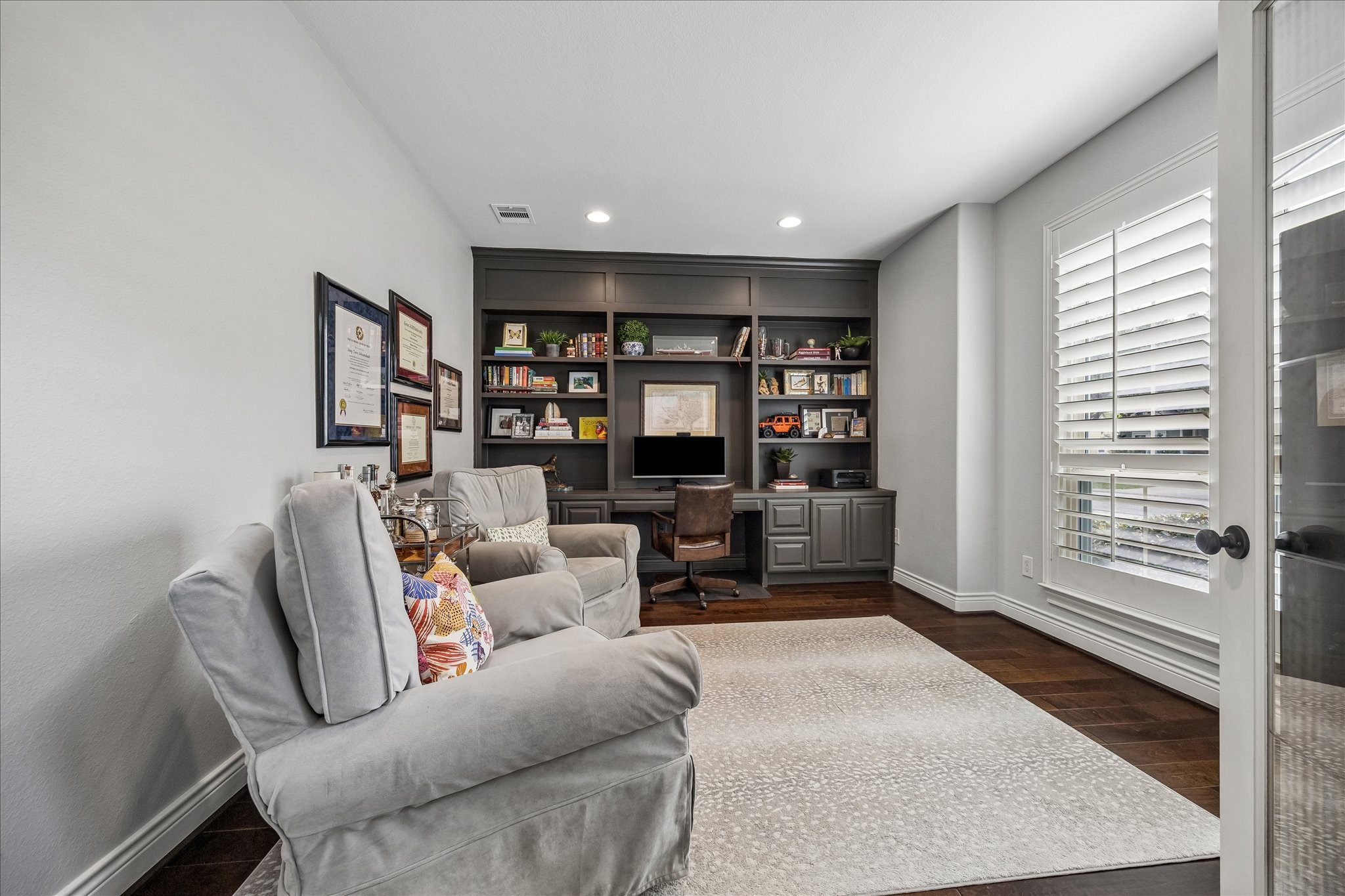 1616 Hewitt Drive Houston, TX 77018 - Photo 4 of 44 Dedicated study offers a quiet retreat for work or reading, anchored by custom built in shelving and cabinetry with space for books, décor, and media.