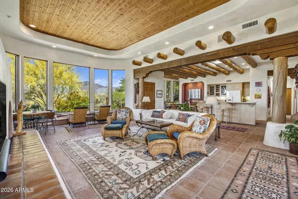 a living room with furniture and large windows