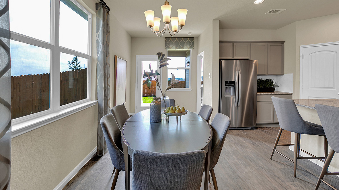 121 Little Walnut Cove Kyle, TX 78640 - Photo 10 of 31 a dining room with furniture a chandelier and wooden floor