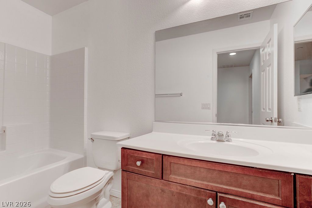 4650 Ranch House Road, Unit 47 North Las Vegas, NV 89031 - Photo 31 of 43 A well-appointed bath features a tiled shower-tub combination and a rich wood vanity with ample storage.
