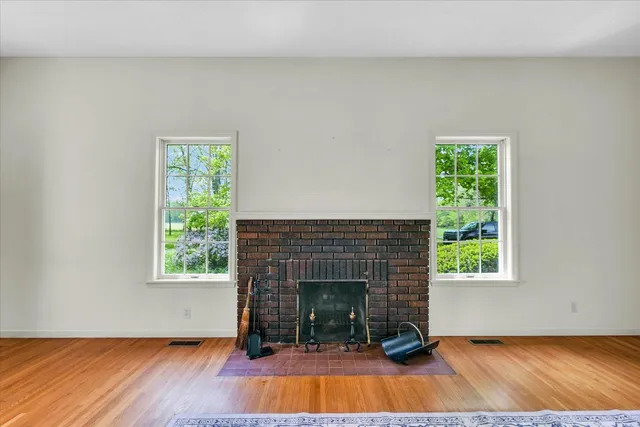a living room with a fireplace and a wooden floor
