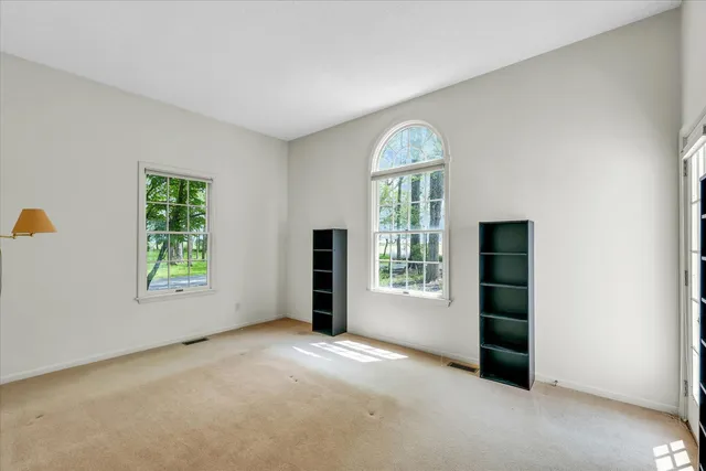 an empty room with windows and closet