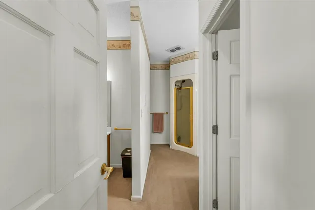 a view of a bathroom from a hallway