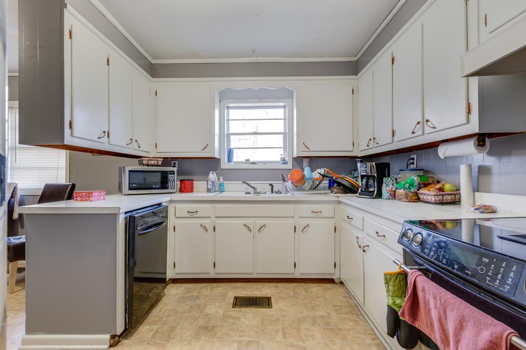 104 Shubert Road Hohenwald, TN 38462 - Photo 8 of 14 U SHAPED EAT IN KITCHEN WITH GORGEOUS WHITE CABINETS AND DISHWASHER REMAINS IN KITCHEN