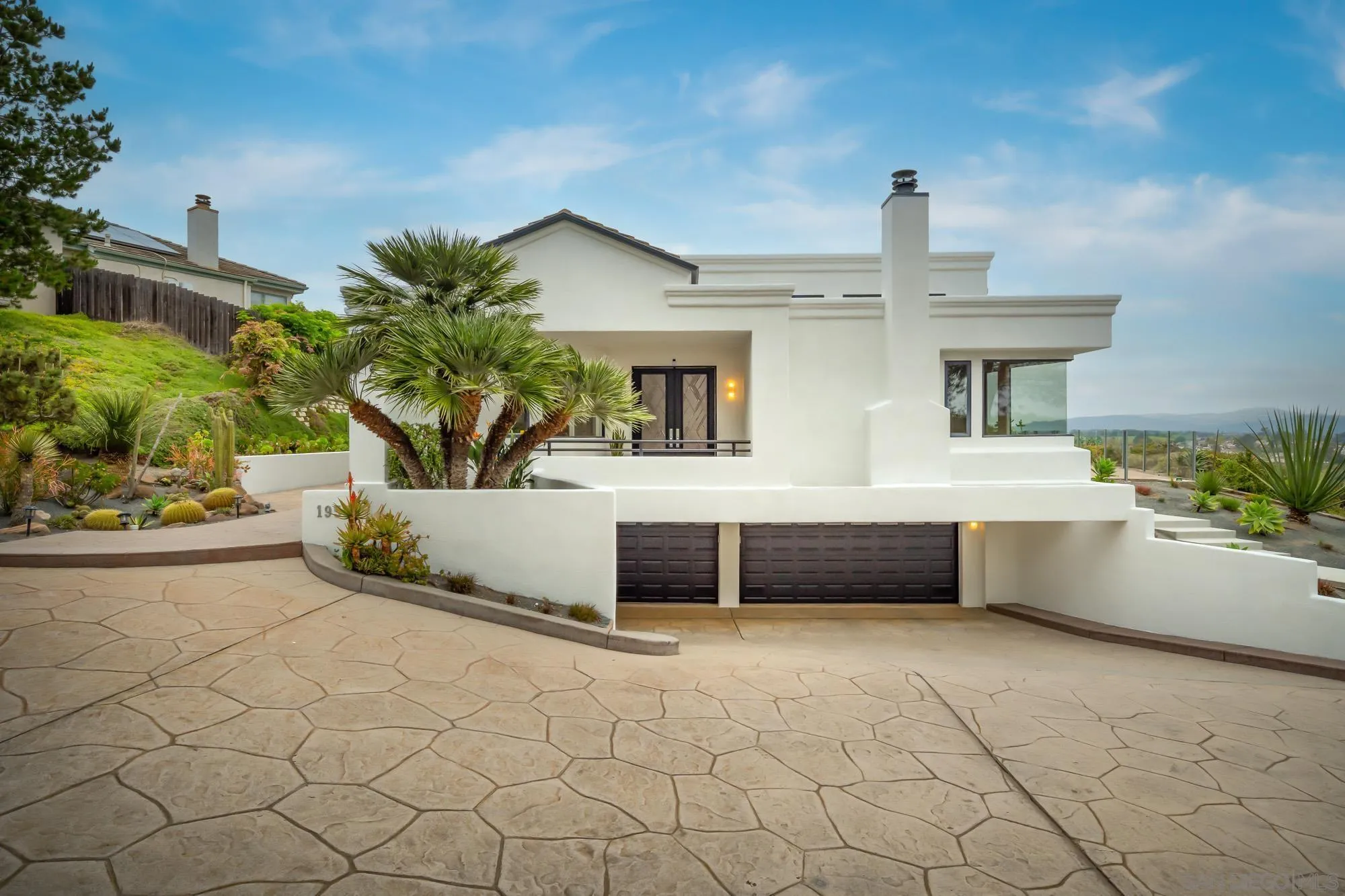 1953 Crest Drive Encinitas, CA 92024 - Photo 14 of 42 a view of a white house with a yard and potted plants