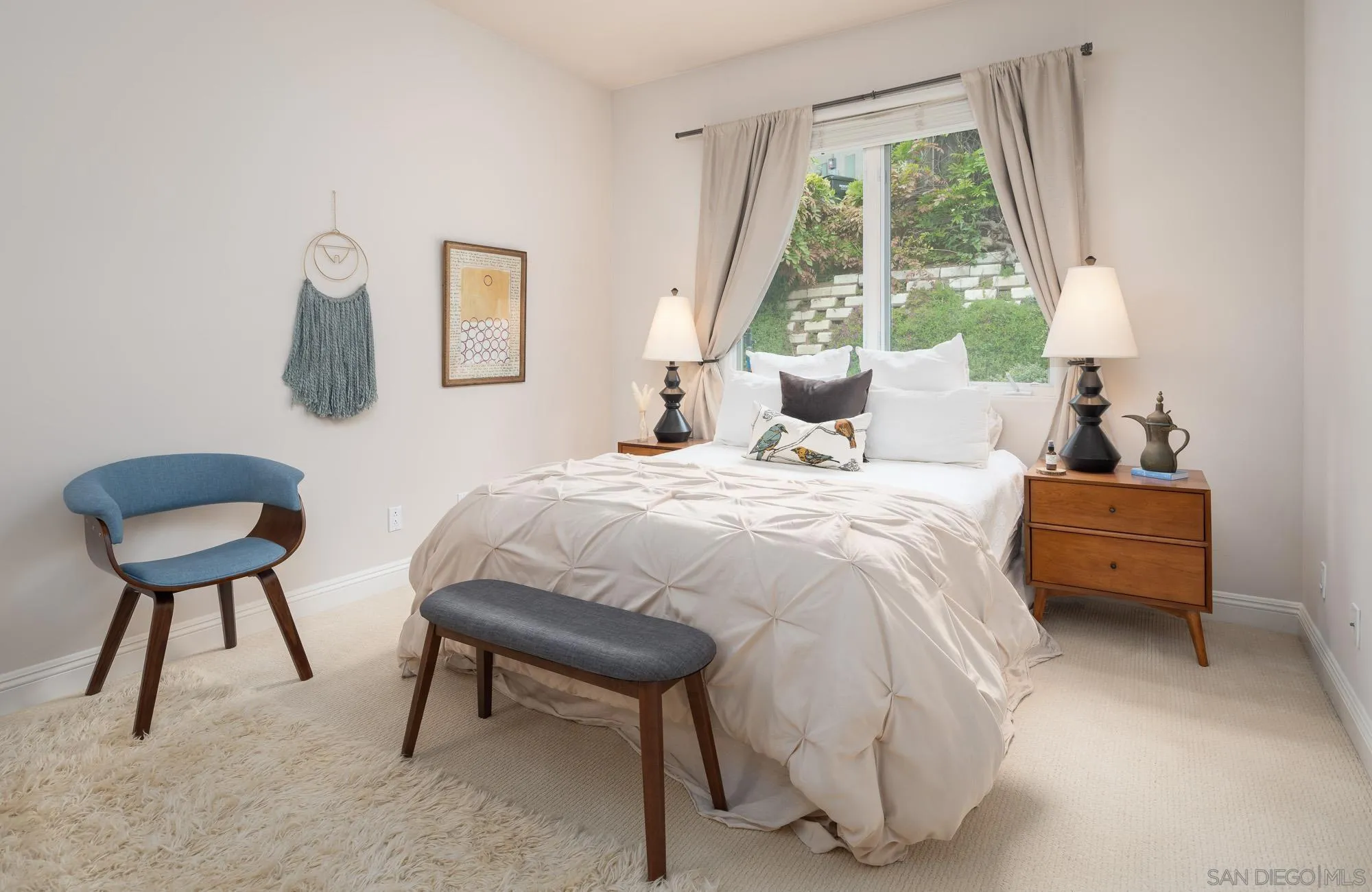 1953 Crest Drive Encinitas, CA 92024 - Photo 32 of 42 a bedroom with a bed and a large mirror next to a window