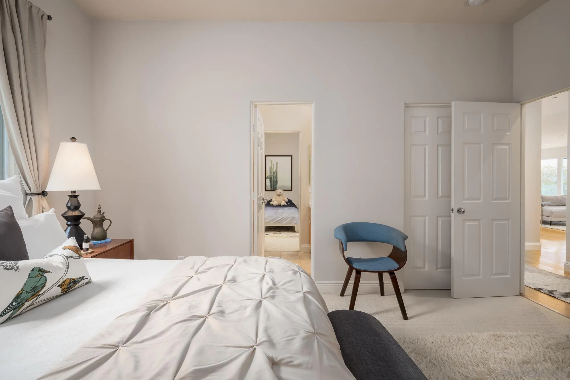 1953 Crest Drive Encinitas, CA 92024 - Photo 33 of 42 a bedroom with a bed and a chair