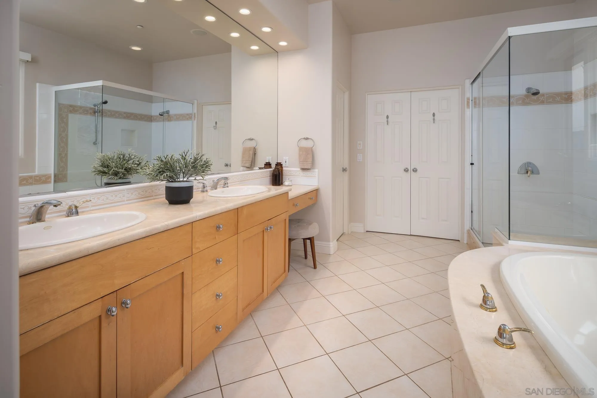 1953 Crest Drive Encinitas, CA 92024 - Photo 38 of 42 a spacious bathroom with a double vanity sink mirror and bathtub