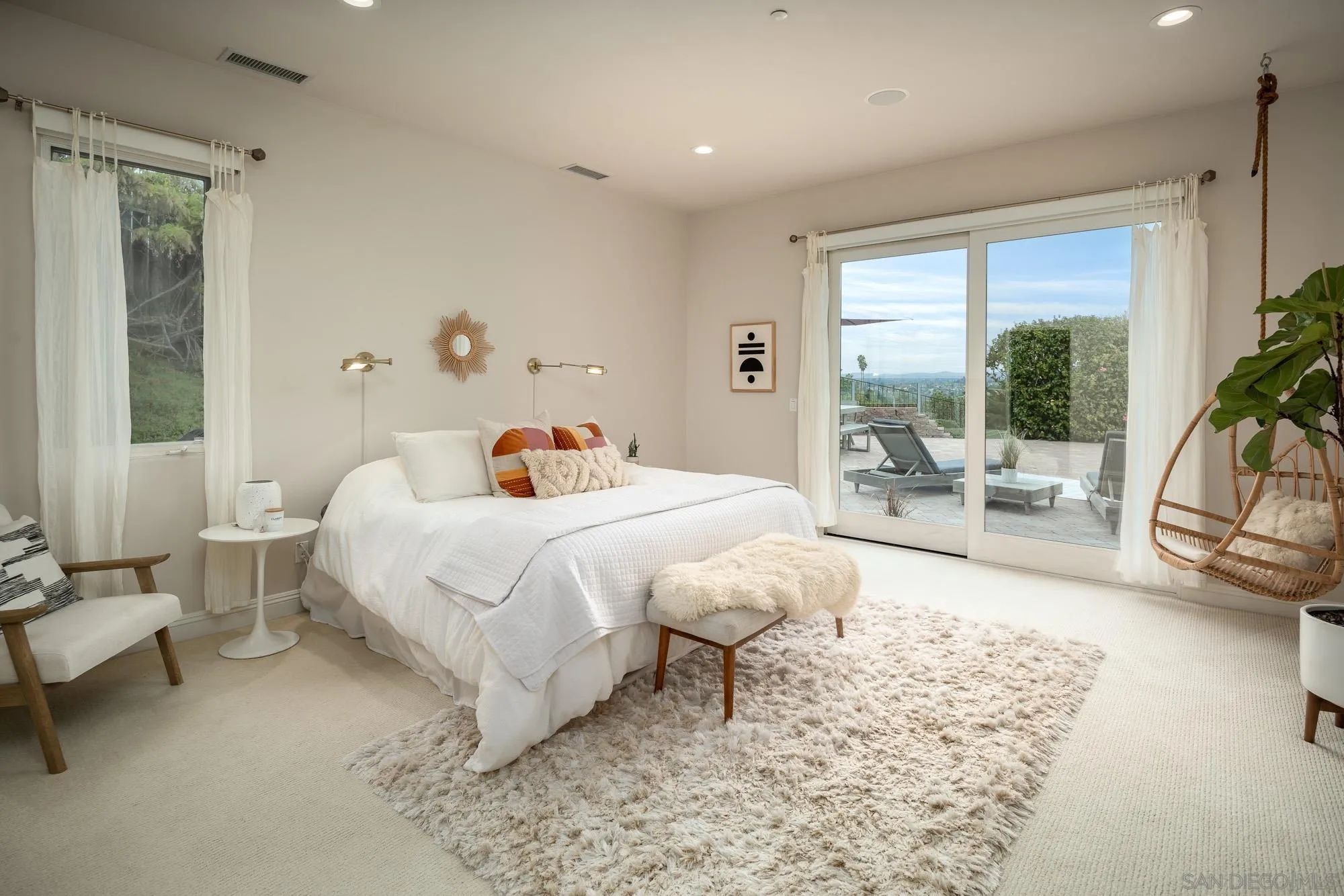 1953 Crest Drive Encinitas, CA 92024 - Photo 41 of 42 a bedroom with a bed and large windows