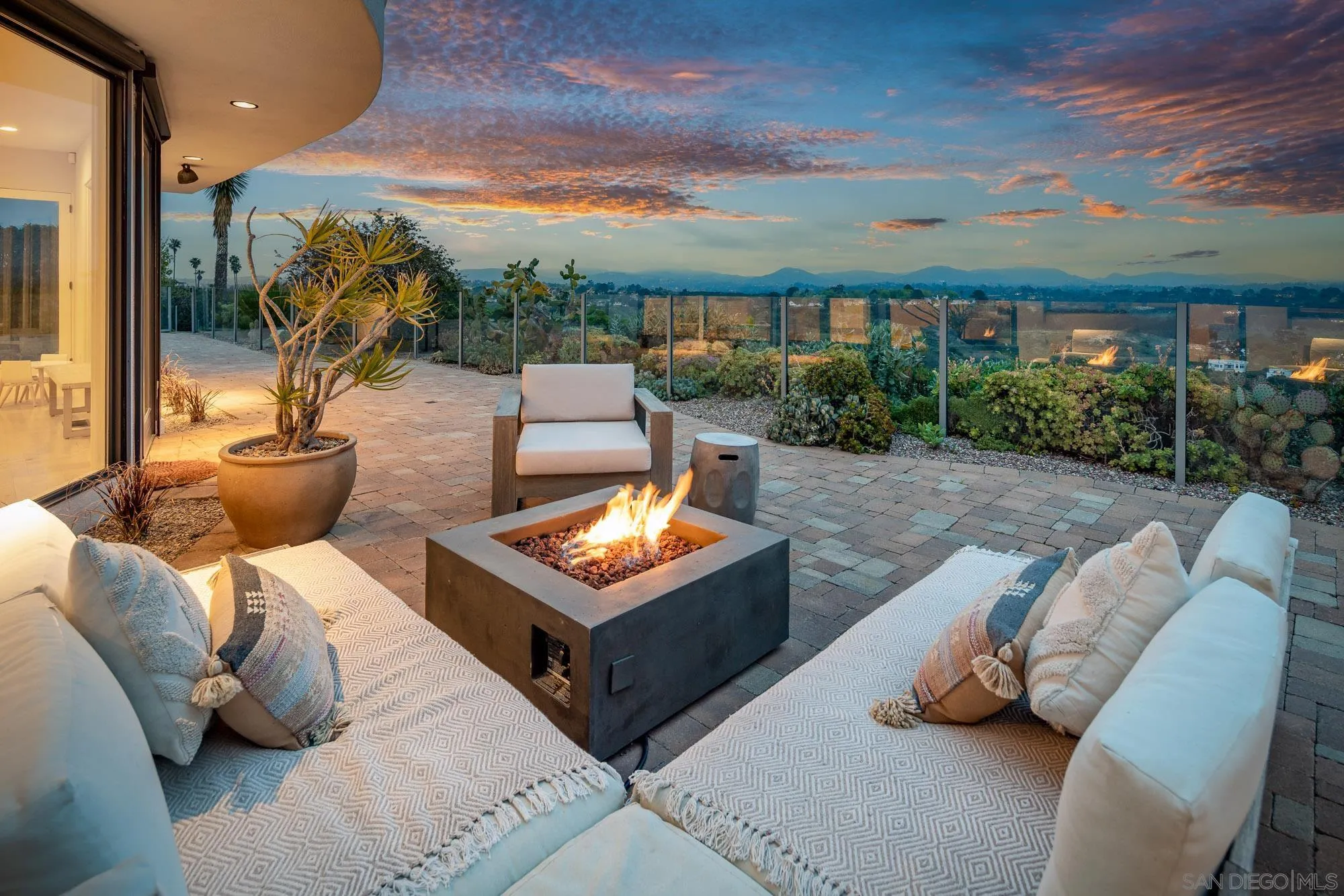 1953 Crest Drive Encinitas, CA 92024 - Photo 6 of 42 a view of a patio with couches and table and chairs and potted plants