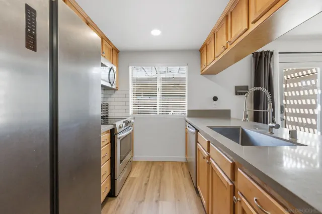 a kitchen with a refrigerator and a sink