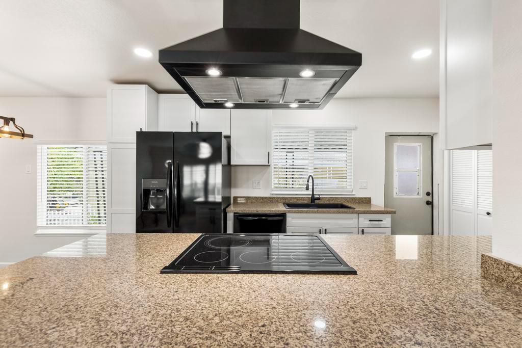 7600 Golden Eye Lane, Unit 43 Citrus Heights, CA 95621 - Photo 13 of 39 a living room with stainless steel appliances granite countertop furniture a fireplace a rug and a window