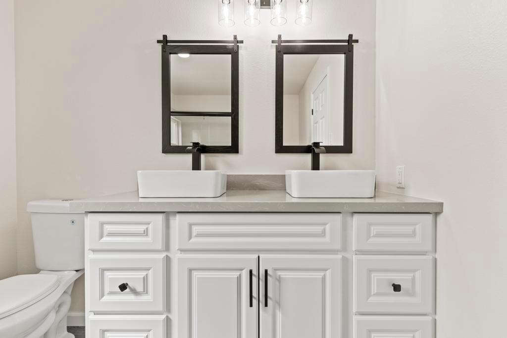 7600 Golden Eye Lane, Unit 43 Citrus Heights, CA 95621 - Photo 19 of 39 a bathroom with double vanity sink a toilet and two mirror