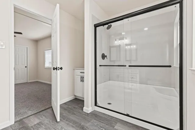 a bathroom with a glass shower door