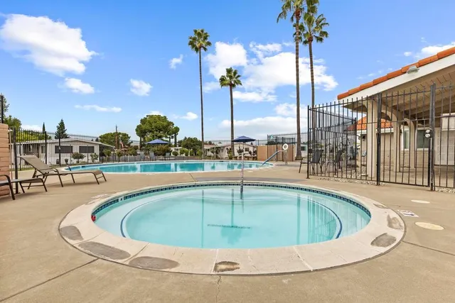 a view of a swimming pool with a lawn chairs
