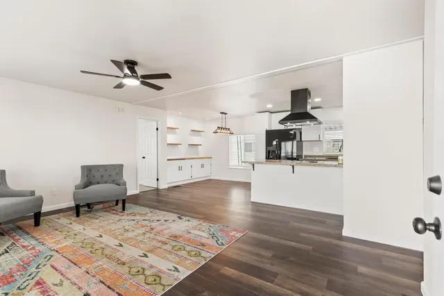 a living room with furniture and view of kitchen