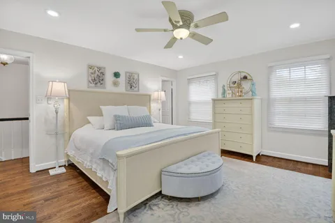 a spacious bedroom with a bed and a chair