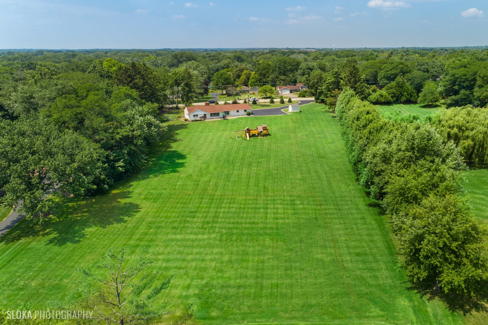 831 Ela Road Inverness, IL 60067 - Photo 43 of 46 a view of a green field with a building in the background